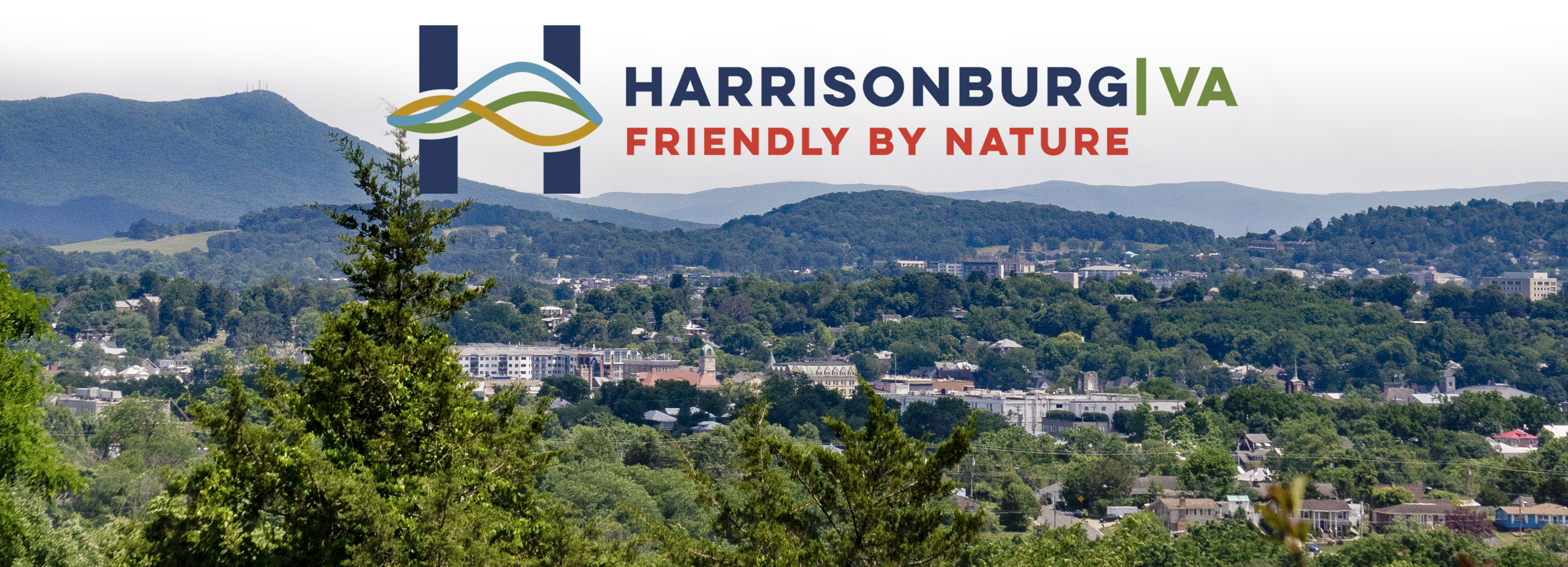 Harrisonburg Va Friendly by Nature logo in bold text over a summer view of the city.