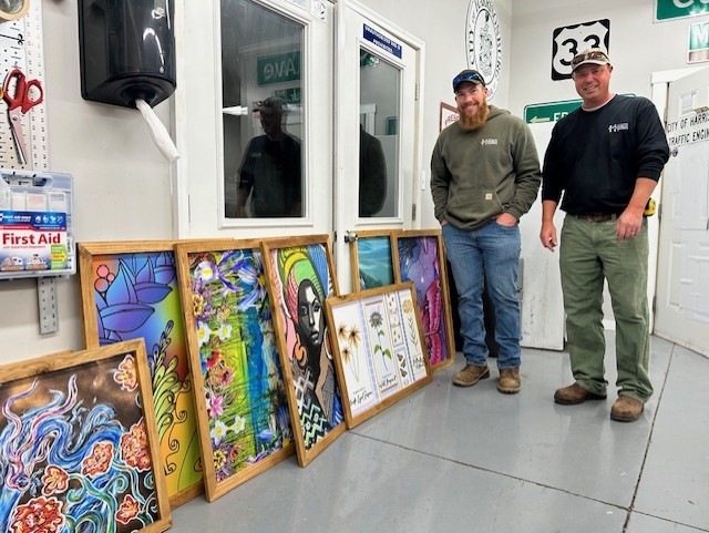 Employees displaying artwork