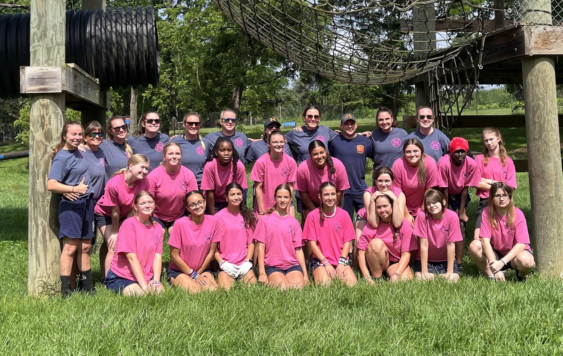 Campers and counselors group photo smiling at the HPD training grounds.