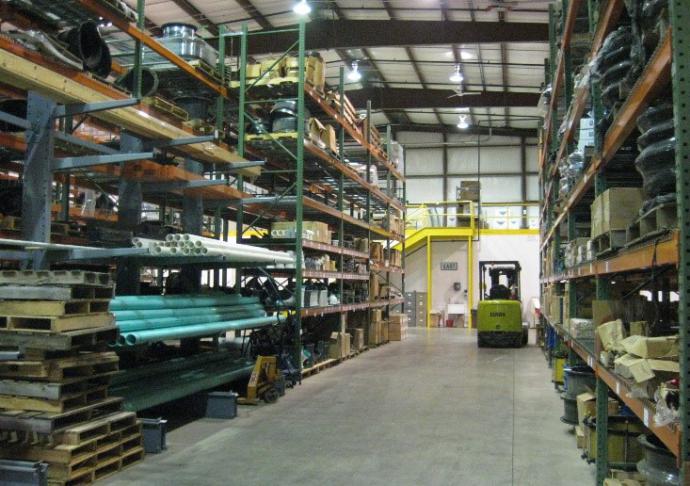 Central Stores warehouse depicting inventory with worker on fork truck picking an order.
