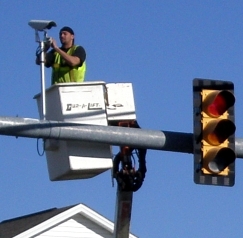 City crew member working on traffic camera