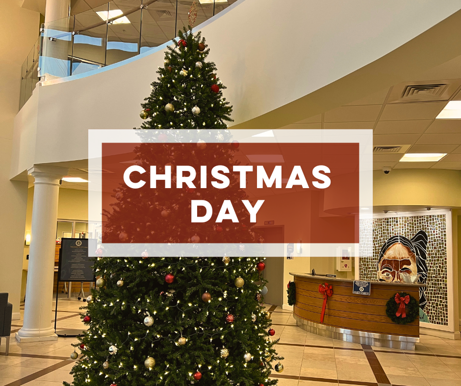 Bold text Christmas Day over Christmas tree in City Hall lobby