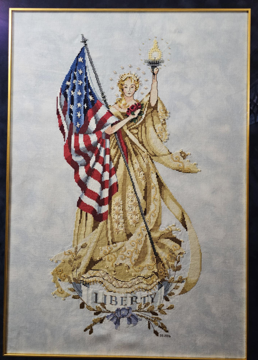 Cross stitch art with a USA flag