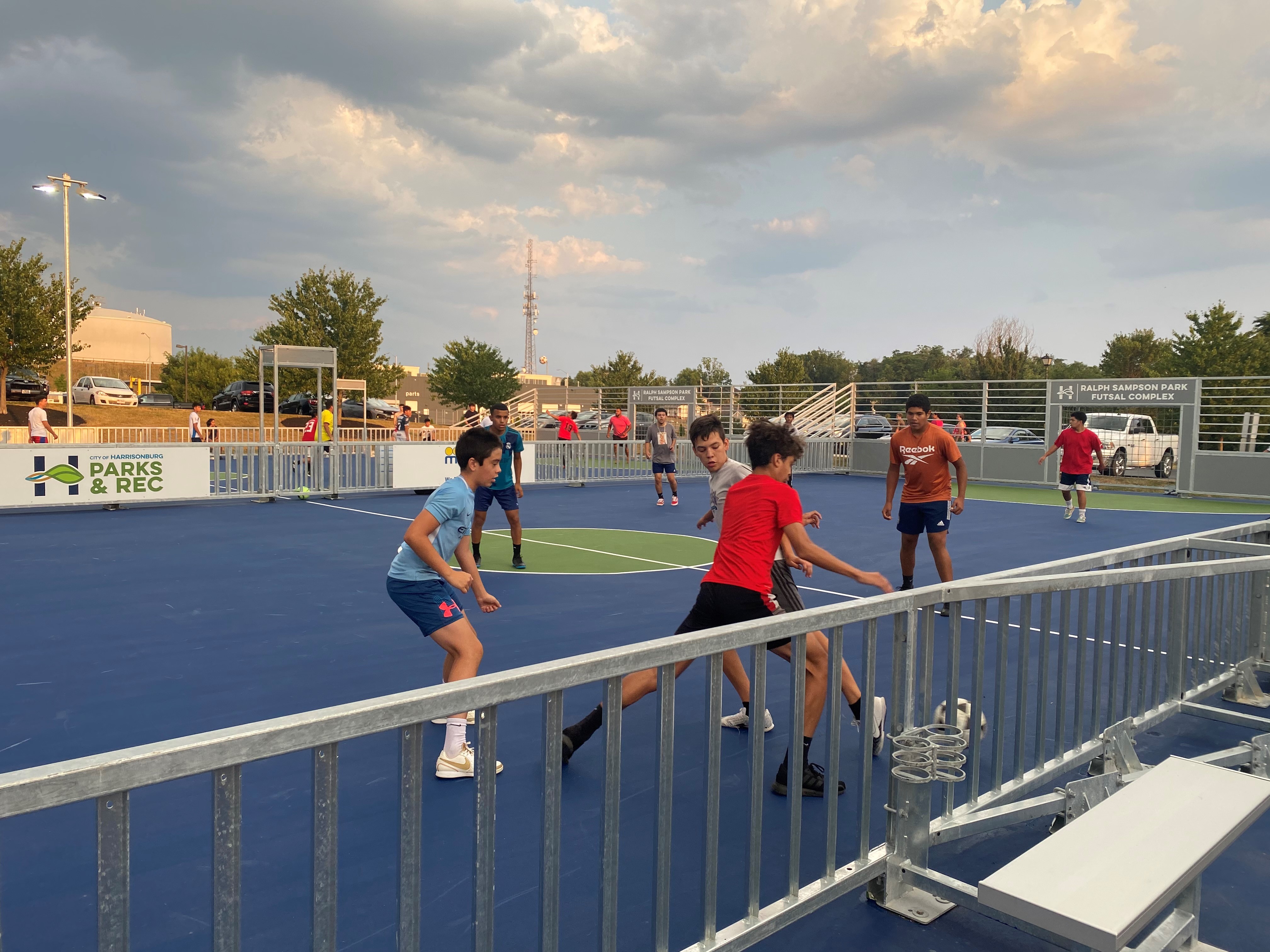 Image of children playing a game of futsal in the futsal courts at Ralph Sampson Park.