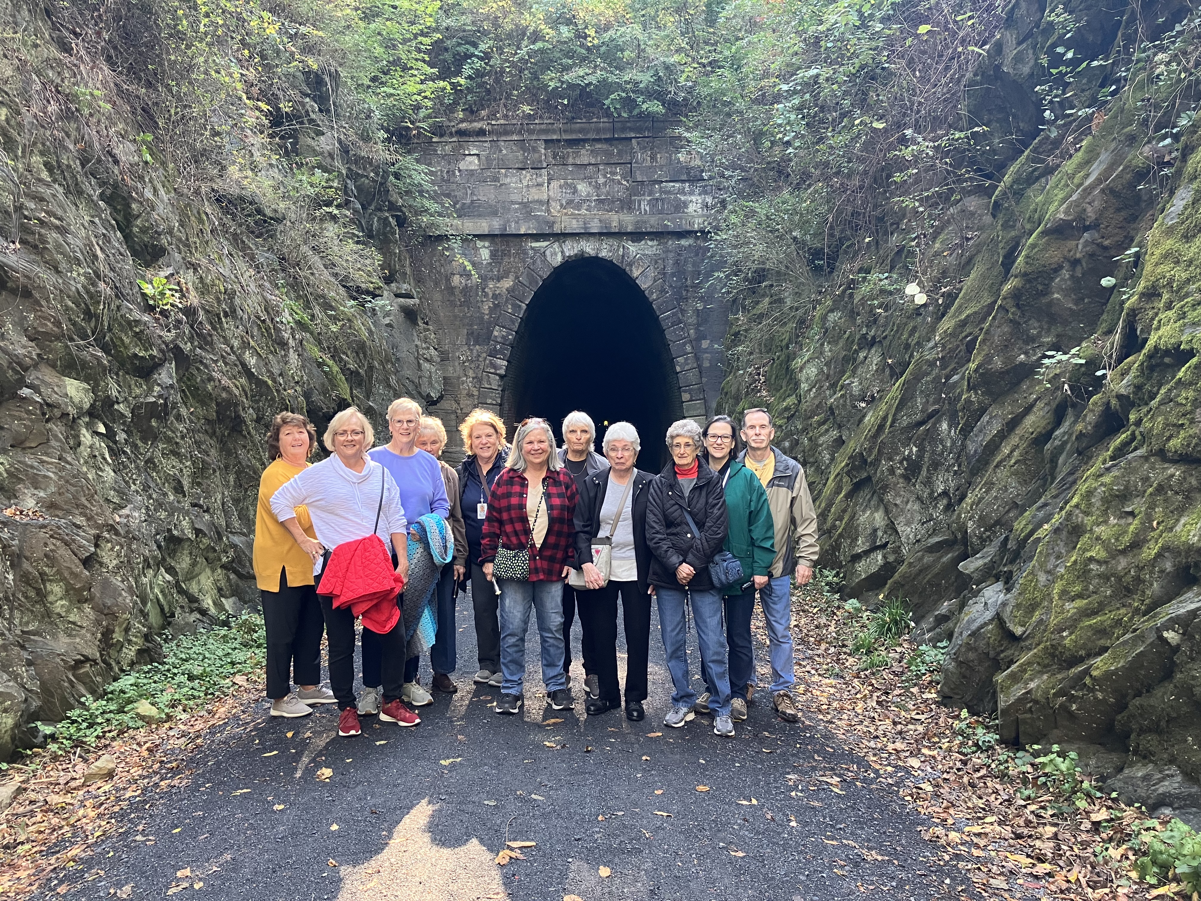 photo of a group of 50 and wiser participants outside of the Blue Ridge Tunnel. Participants are dressed for a hike. 