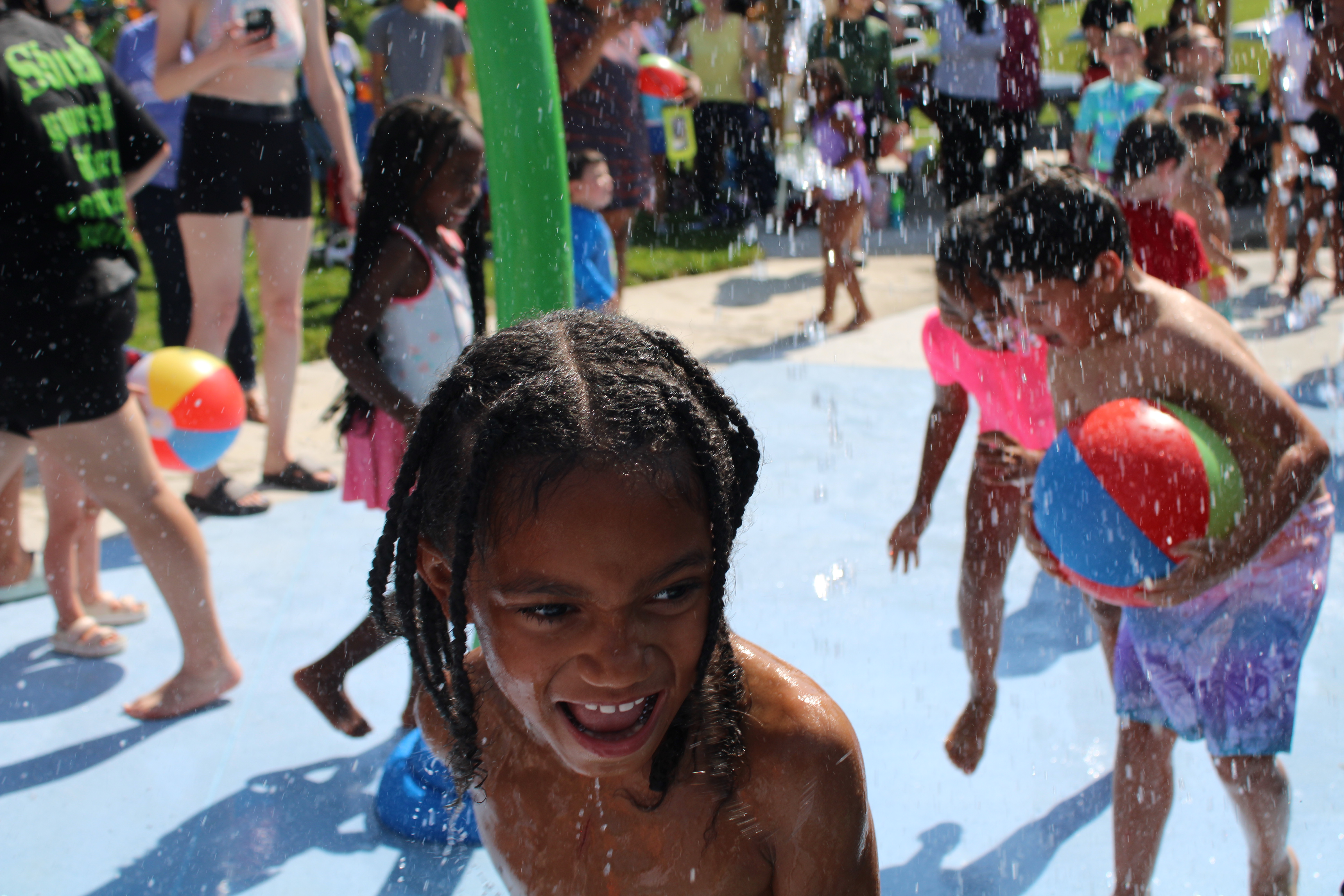 Image of children playing at the Spraygrounds. 