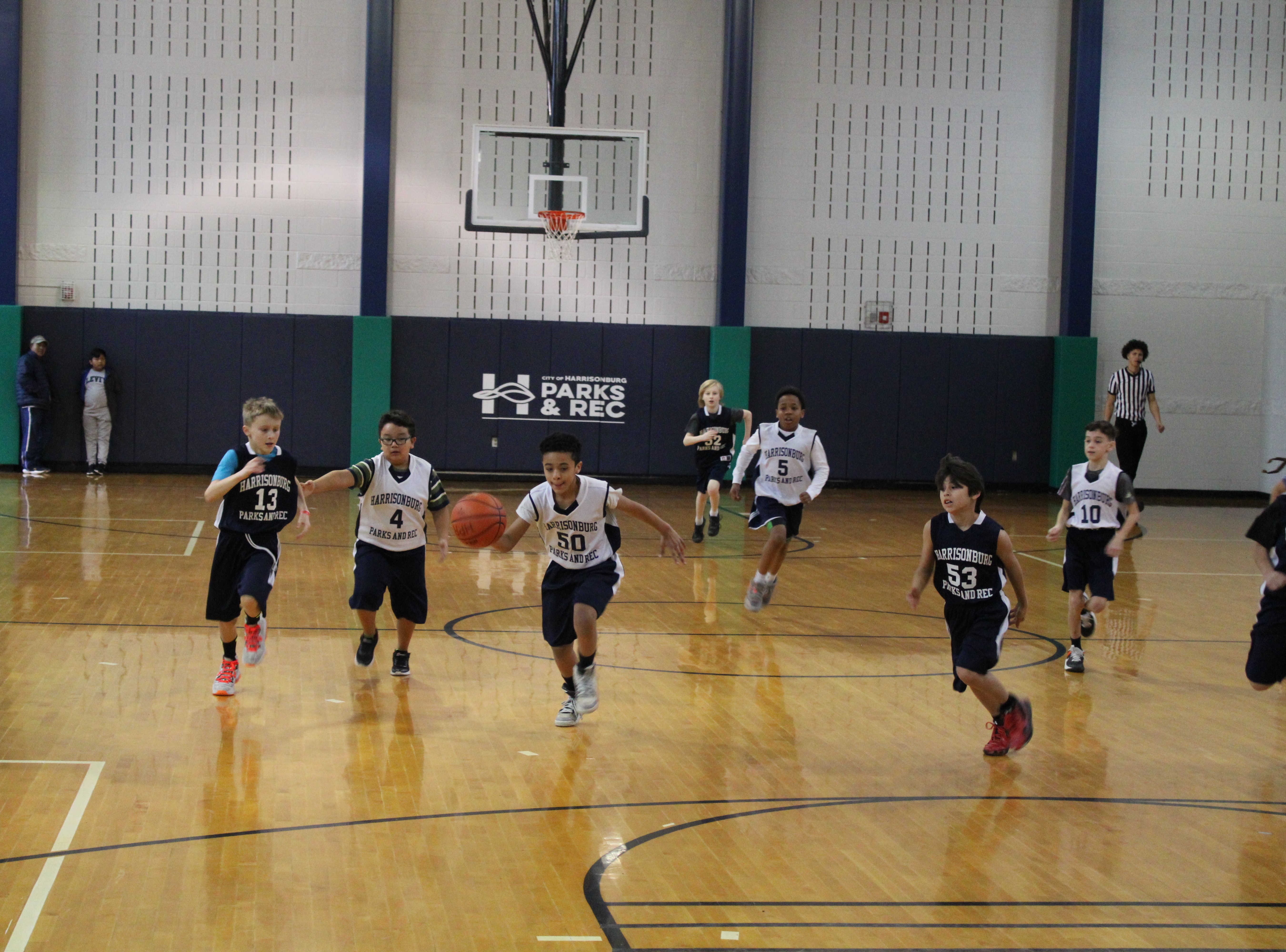 Youth age boys playing basketball on a court