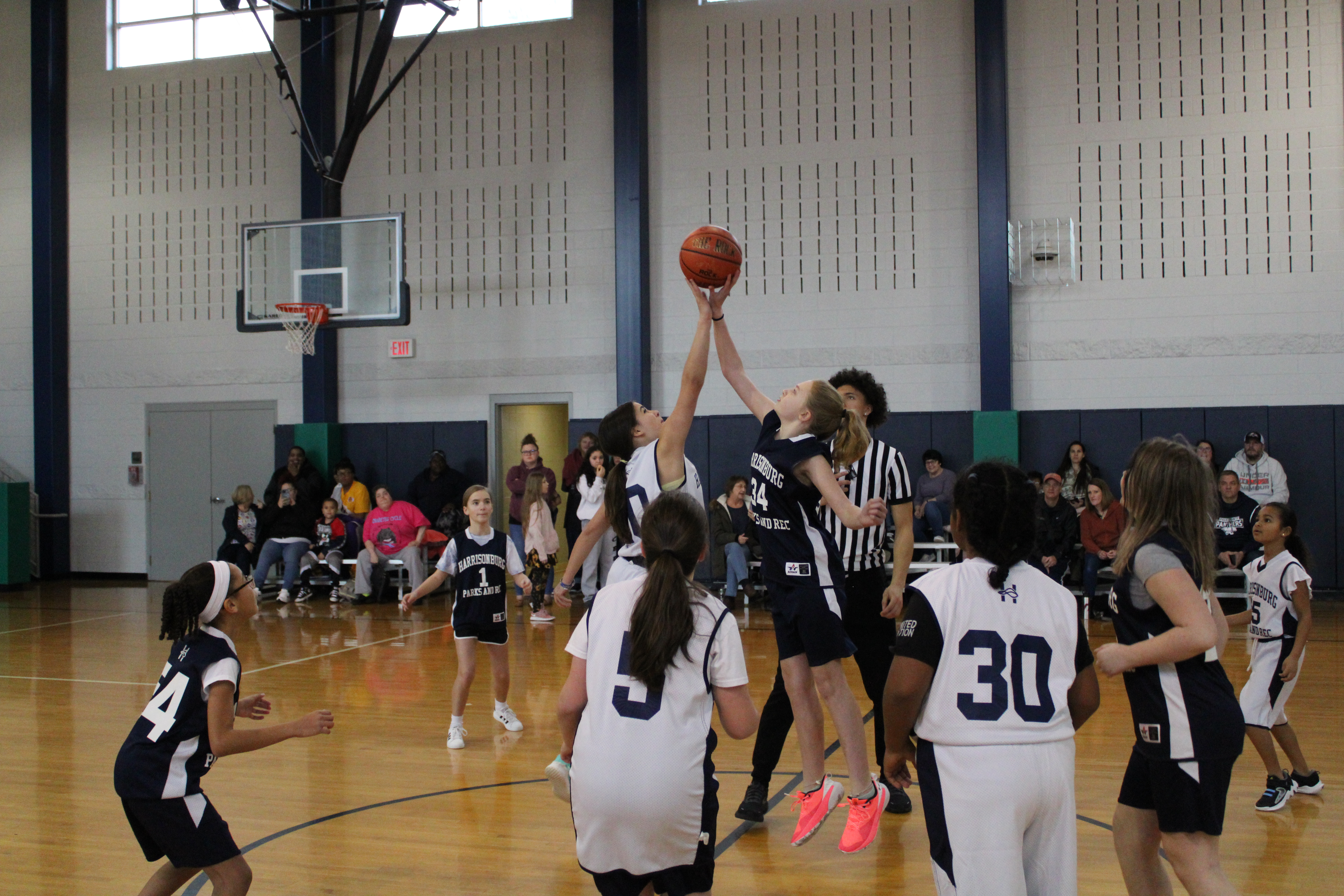 Youth girls playing basketball on a court