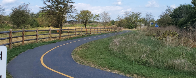 Walking and biking trail with fence beside the trail